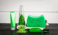 Green composition beauty treatment products in green colors: shampoo, soap, bath salt, oil. Royalty Free Stock Photo