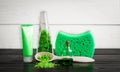 Green composition beauty treatment products in green colors: shampoo, soap, bath salt, oil. Royalty Free Stock Photo