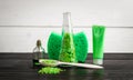 Green composition beauty treatment products in green colors: shampoo, soap, bath salt, oil. Royalty Free Stock Photo