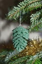 Green cone hanging on christmas tree