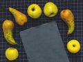 Green Conference pears, green apples, a cutting board slate on b