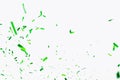 Green confetti elements on a white background. Confetti shot at a party, anniversary go birthday. Festive mood. Festive decor