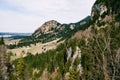 Green coniferous forests on the mountains, with thin layers of snow