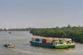 Green container barges on Song Sai Gon river, Ho Chi Minh City, Vietnam