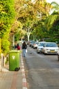 Green container on edge of sidewalk ready for collection in Tel Aviv