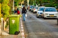 Green container on edge of sidewalk ready for collection in Tel Aviv