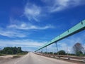 Green contena bridge near highway on industrial place