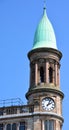 Green copper ogee dome and tower clock on old Robinson and Cleavers