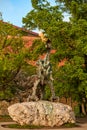 A green copper sculpture of a fire-breathing dragon in the ancient Wawel Castle in the center of the European city of Krakow