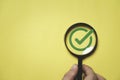 Green correct or tick sign mark inside of magnifier glass for focus approve document and project concept Royalty Free Stock Photo