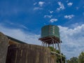 Green Corrugated water tank with blue sky