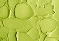 Green cosmetic clay cucumber facial mask, avocado face cream, green tea matcha body wrap texture close up, selective focus.