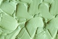 Green cosmetic clay cucumber facial mask, avocado face cream, green tea matcha body wrap texture close up, selective focus. Royalty Free Stock Photo
