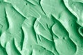 Green cosmetic clay facial mask, cream, body scrub texture close up, selective focus. Abstract background Royalty Free Stock Photo