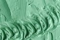 Green cosmetic clay texture close up. Abstract background with brush strokes Royalty Free Stock Photo