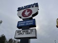 Zaxbys restaurant Now Hiring message on a street sign