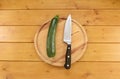 Green courgette with a knife on a chopping board Royalty Free Stock Photo