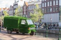 Green covered minivan Piaggio Porter utility parked on the street