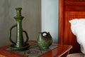 Green craftsman pottery displayed on side table