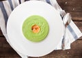 Green Cream of asparagus soup with shrimp in a white bowl on a r Royalty Free Stock Photo