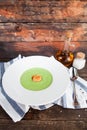 Green Cream of asparagus soup with shrimp in a white bowl on a r Royalty Free Stock Photo