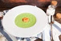 Green Cream of asparagus soup with shrimp in a white bowl on a r Royalty Free Stock Photo