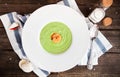 Green Cream of asparagus soup with shrimp in a white bowl on a r Royalty Free Stock Photo