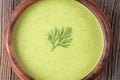 Green cream soup healthy food in bowl with dill