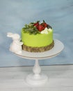 A green creamchease cake with berries and marmalade