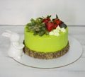 A green creamchease cake with berries and marmalade