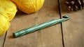 Green Crochet Hook with Yellow Yarn and Pinecone Royalty Free Stock Photo