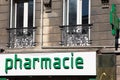 Green cross and french text pharmacie means pharmacy lighting sign on wall building facade Royalty Free Stock Photo