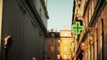 Green cross LED sign at the entrance to pharmacy in Trieste, Italy Royalty Free Stock Photo