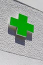 Green cross logo of Pharmacy sign in street Royalty Free Stock Photo