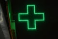 Green cross pharmacies at night in the city. Glowing with LED lamps, the green cross of the hospital Royalty Free Stock Photo