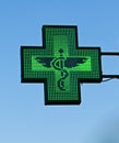 Green cross pharmacy store sign with caduceus. Pharmacy sign.