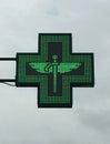 Green cross pharmacy store sign with caduceus. Pharmacy sign. Royalty Free Stock Photo