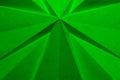 Green cross shaped folded paper as abstract Christmas background.