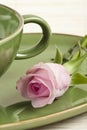 Green cup and rose