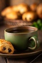Green cup of tea with mini chocolate bun Royalty Free Stock Photo
