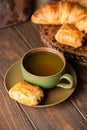 Green cup of tea with mini chocolate bun Royalty Free Stock Photo