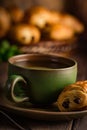 Green cup of tea with mini chocolate bun Royalty Free Stock Photo