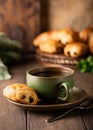 Green cup of tea with mini chocolate bun Royalty Free Stock Photo