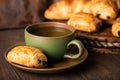 Green cup of tea with mini chocolate bun Royalty Free Stock Photo