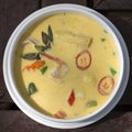 Green curry creamy soup with coconut milk, shrimp, red pepper, bean in white bowl, Thai cuisine Royalty Free Stock Photo