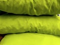 Green cushions of cotton textiles close up
