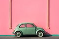 green cute car standing in front of pink wall, copy space