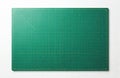 Green cutting mat with grid and inch scale. Patchwork, crafting tool with geometric design on white background for measuring Royalty Free Stock Photo