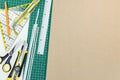 Green cutting mat with school tools and office supplies on desk Royalty Free Stock Photo
