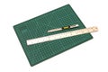Green cutting mats with iron ruler and cuter Royalty Free Stock Photo